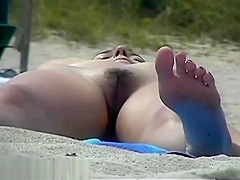 Busty girl shows her mighty jugs on a nudist beach