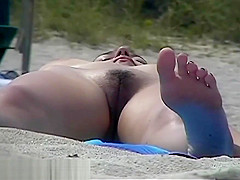 Busty girl shows her mighty jugs on a nudist beach