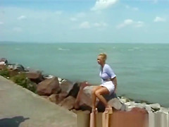 blonde peeing on the beach