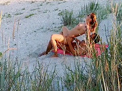 Amateur couple got caught having sex on the beach by voyeur.