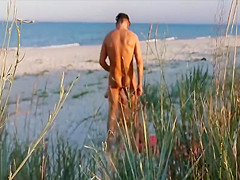 Amateur couple got caught having sex on the beach by voyeur.