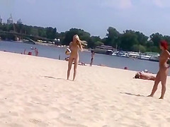 TWO TEENS AT A NUDIST BEACH PLAYING BEACH BALL