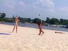 TWO TEENS AT A NUDIST BEACH PLAYING BEACH BALL