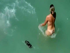 Beach couple sex in the sea