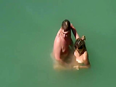 Beach couple sex in the sea