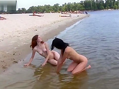 TWO NUDIST BEACH TEENS ON SAND AND IN SEA