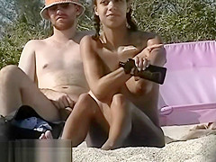 Dark haired nudist spied pissing on the beachvoyeur voyeur