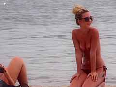 Slim babe with sexy body filmed with her tits out on the beach