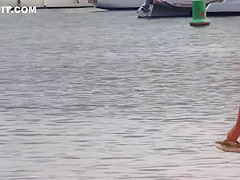 Slim babe with sexy body filmed with her tits out on the beach