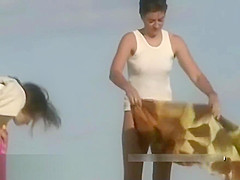 Naked hotties followed around by a nude beach voyeur