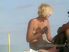 Naked hotties followed around by a nude beach voyeur