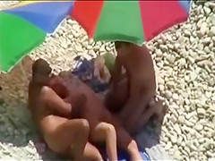 Threesome sex fun on public beach caught on voyeur cam