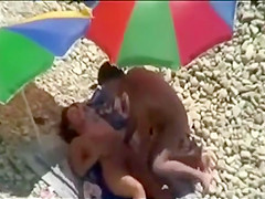 Threesome sex fun on public beach caught on voyeur cam