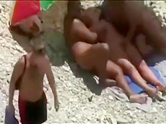 Threesome sex fun on public beach caught on voyeur cam