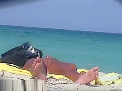 A sexy model couple on the beach voyeur video