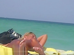 A sexy model couple on the beach voyeur video