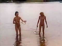 Nude girls outdoor on public beach having fun