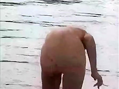 Nude girls outdoor on public beach having fun