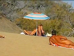 Slutwife masturbating for pervs in a beach