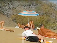 Slutwife masturbating for pervs in a beach