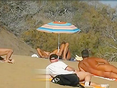 Slutwife masturbating for pervs in a beach