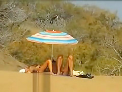 Slutwife masturbating for pervs in a beach