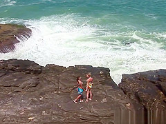 Two naughty girls drive to a desolate spot on the beach