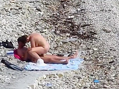Couple fucked on a public beach while as people walked near