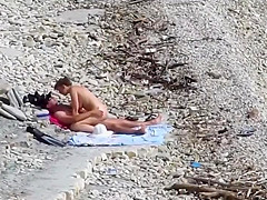 Couple fucked on a public beach while as people walked near