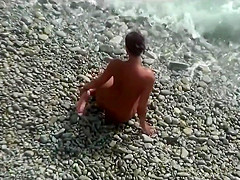 Girl with plug in the ass poses for a guy at public beach 2