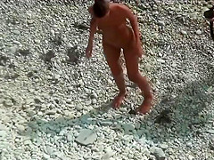 Girl with plug in the ass poses for a guy at public beach 2