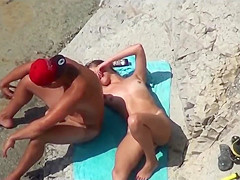 Couple of mutually masturbating to orgasm at a public beach