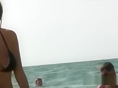 Beautiful fresh faced teen plays at the beach nude