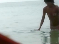 Beautiful fresh faced teen plays at the beach nude