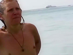 Beautiful fresh faced teen plays at the beach nude