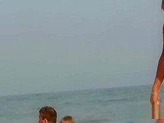 Beautiful fresh faced teen plays at the beach nude