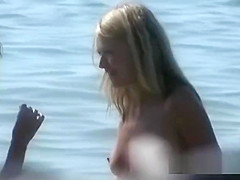 Beautiful fresh faced teen plays at the beach nude