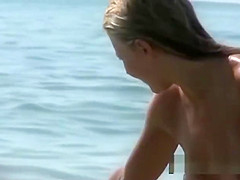 Beautiful fresh faced teen plays at the beach nude