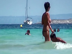 Two South European babes topless on the beach