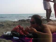 Several sexy nude girls caught on a beach with a spy cam