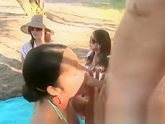 Men showing of in tight thongs on the beach