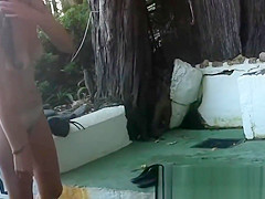 Spy cam shot of a hot nudist babe tanning on the beach