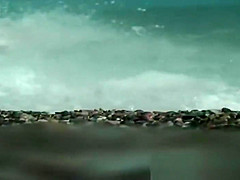 Sexy toned body walking naked on a crowded beach