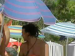 Sexy nudist chicks are captured on camera on a beach