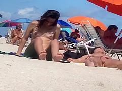 Beautiful Latina showing her pussy on nude beach