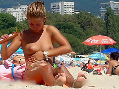 Fine looking topless girl at the beach