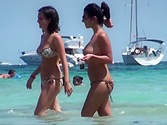 Topless brunette friends with nice tits on the beach