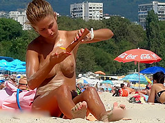 Fine looking topless girl at the beach