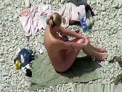 Couple in the beach sunbathing