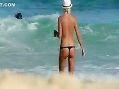 Skinny topless girl enters the water